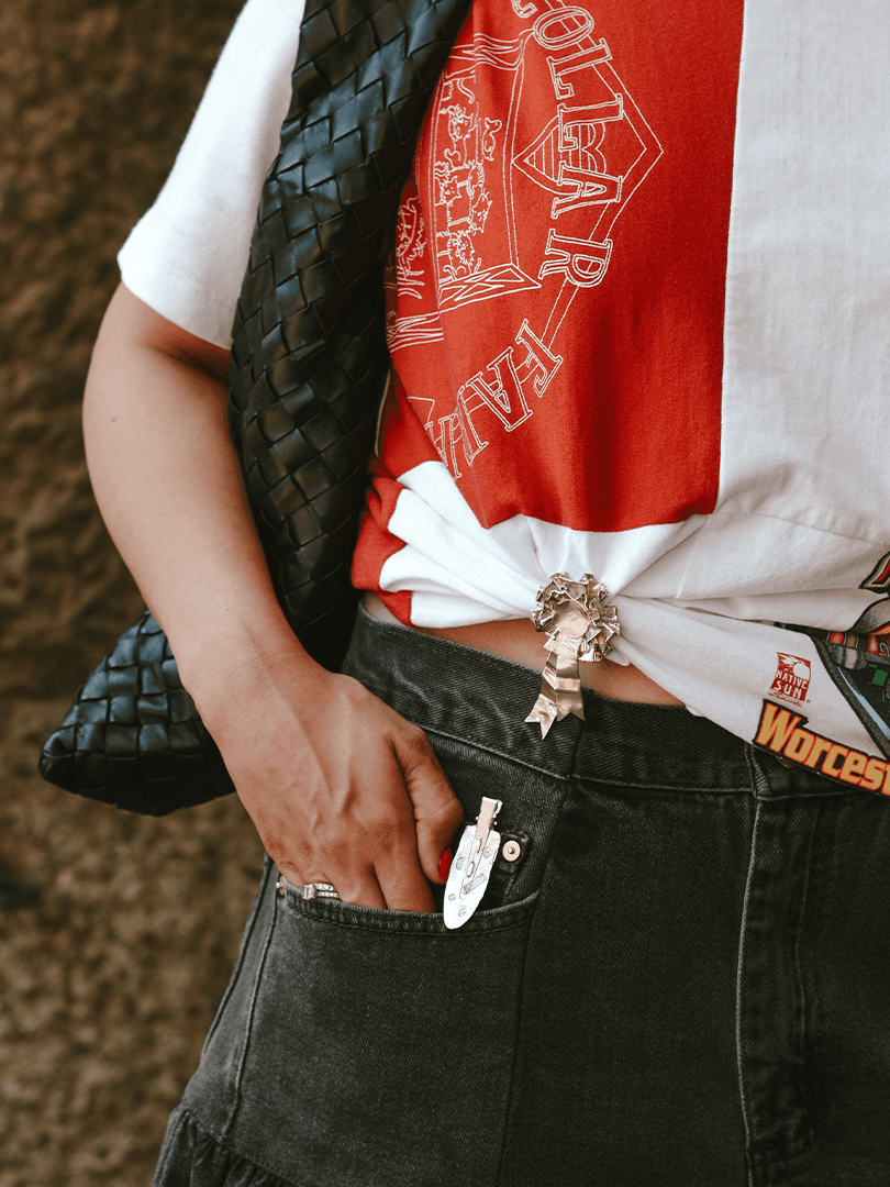 The Ouze brooches styled on a t-shirt