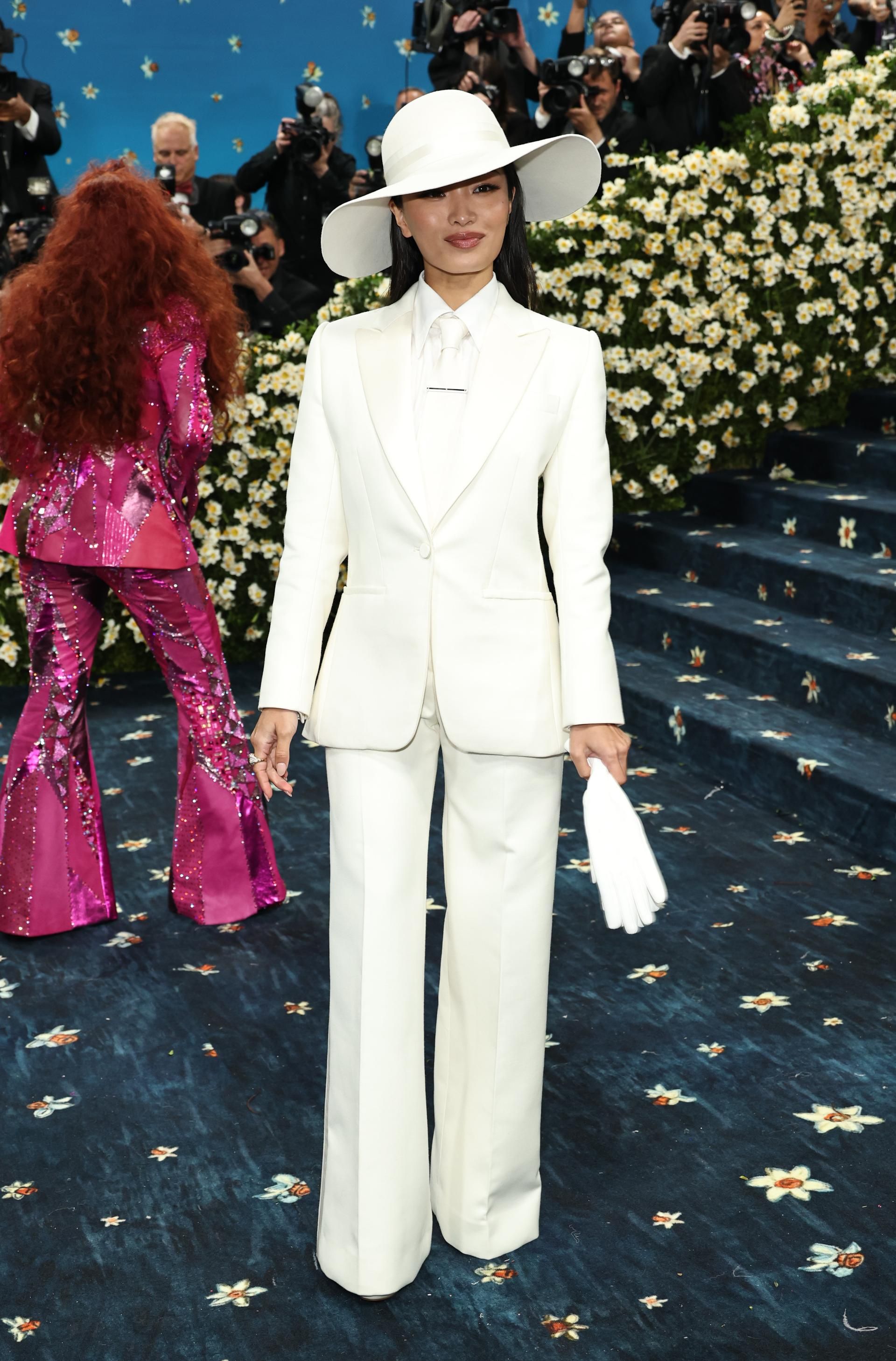 Anna Sawai attends the Met Gala in a custom white suit by Dior