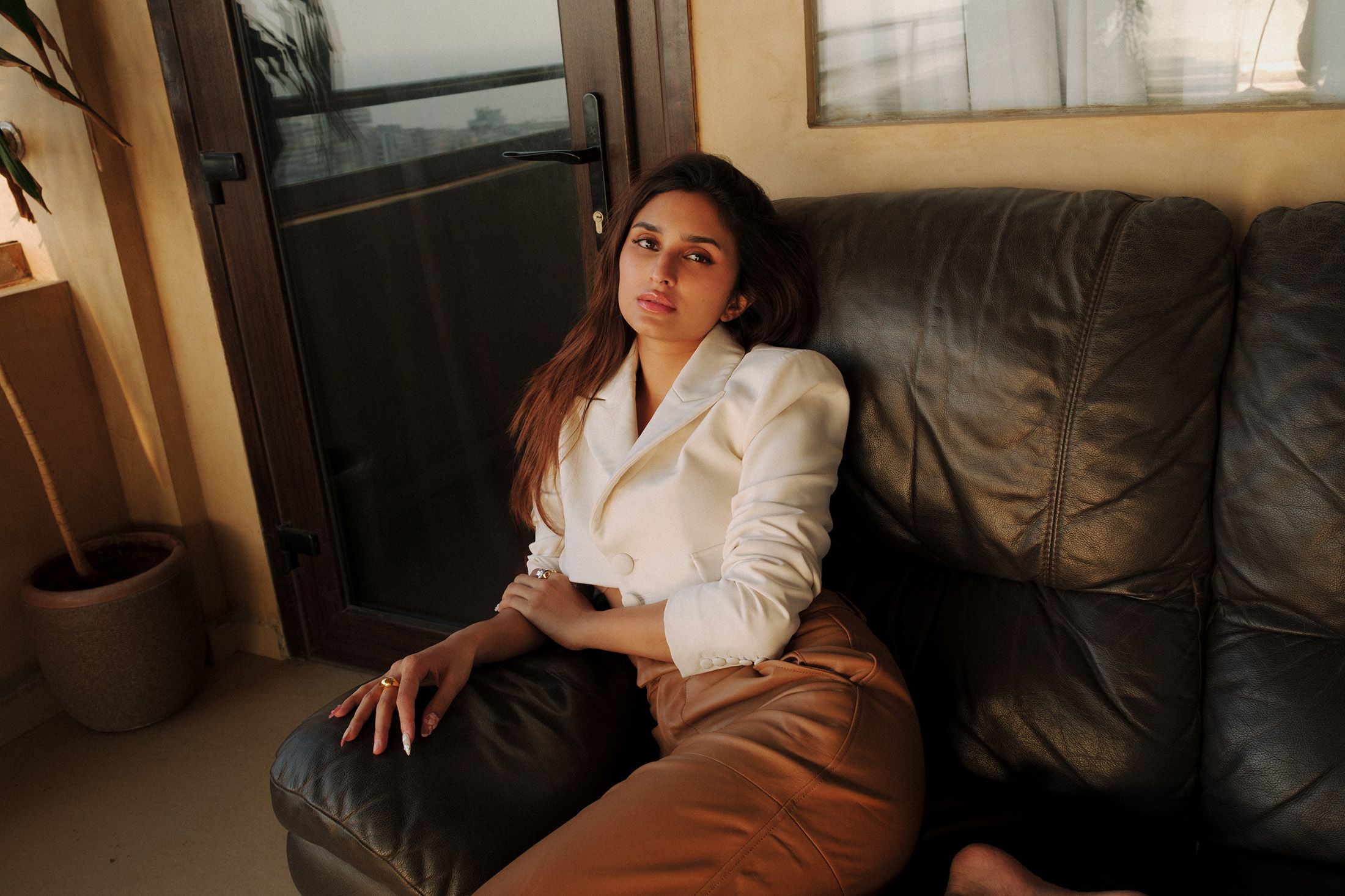 Alaviaa Jaaferi lounging on a sofa on her terrace