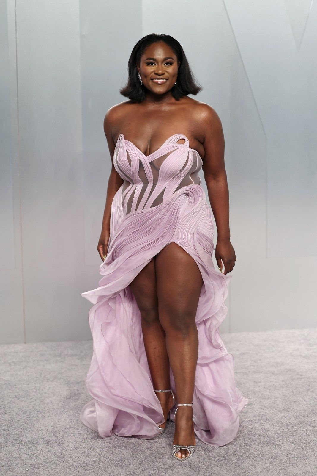 Danielle Brooks in a lilac Gaurav Gupta gown with a sheer bodice and a leg slit at the Vanity Fair Oscar party