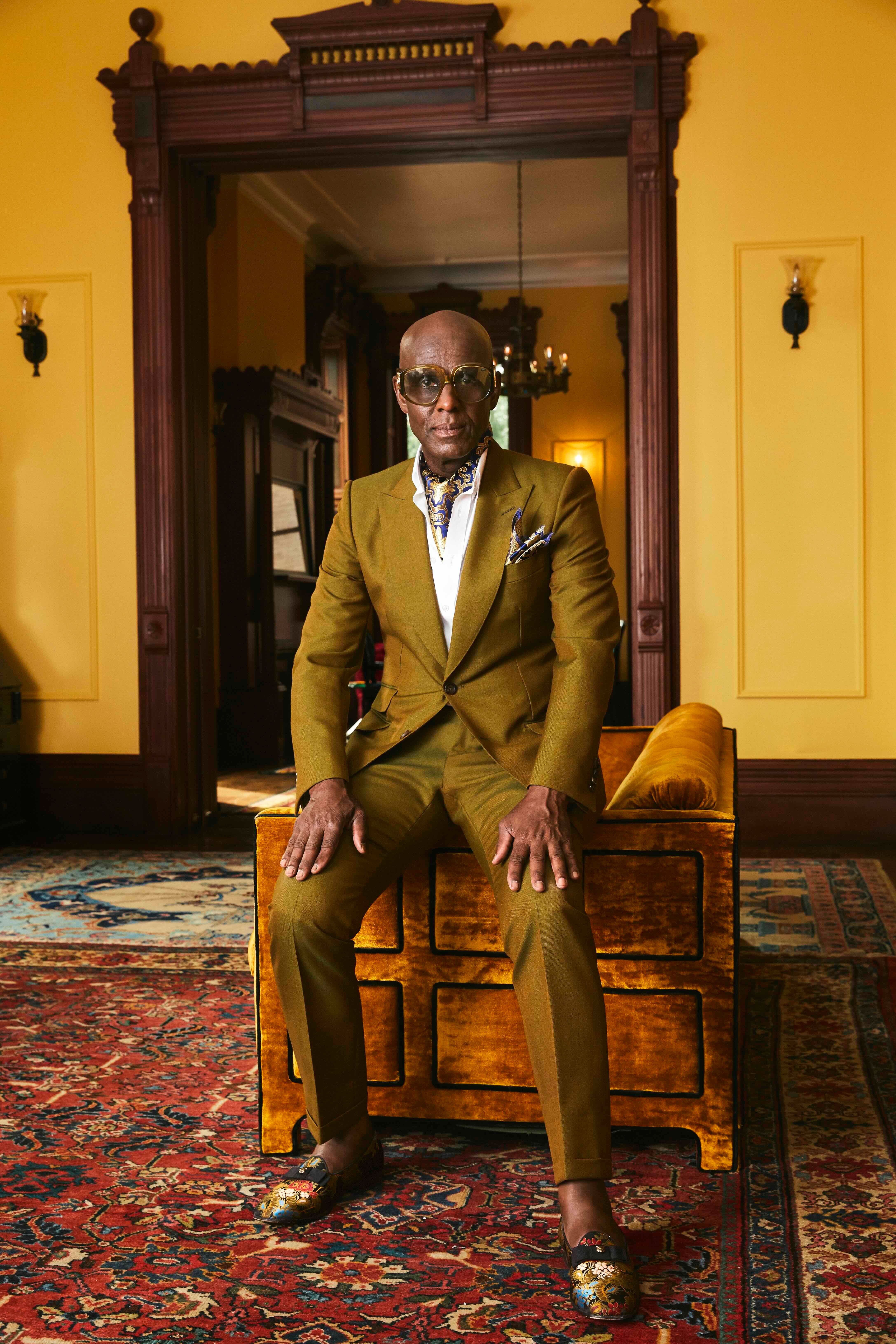 Dapper Dan posing in a tailored suit