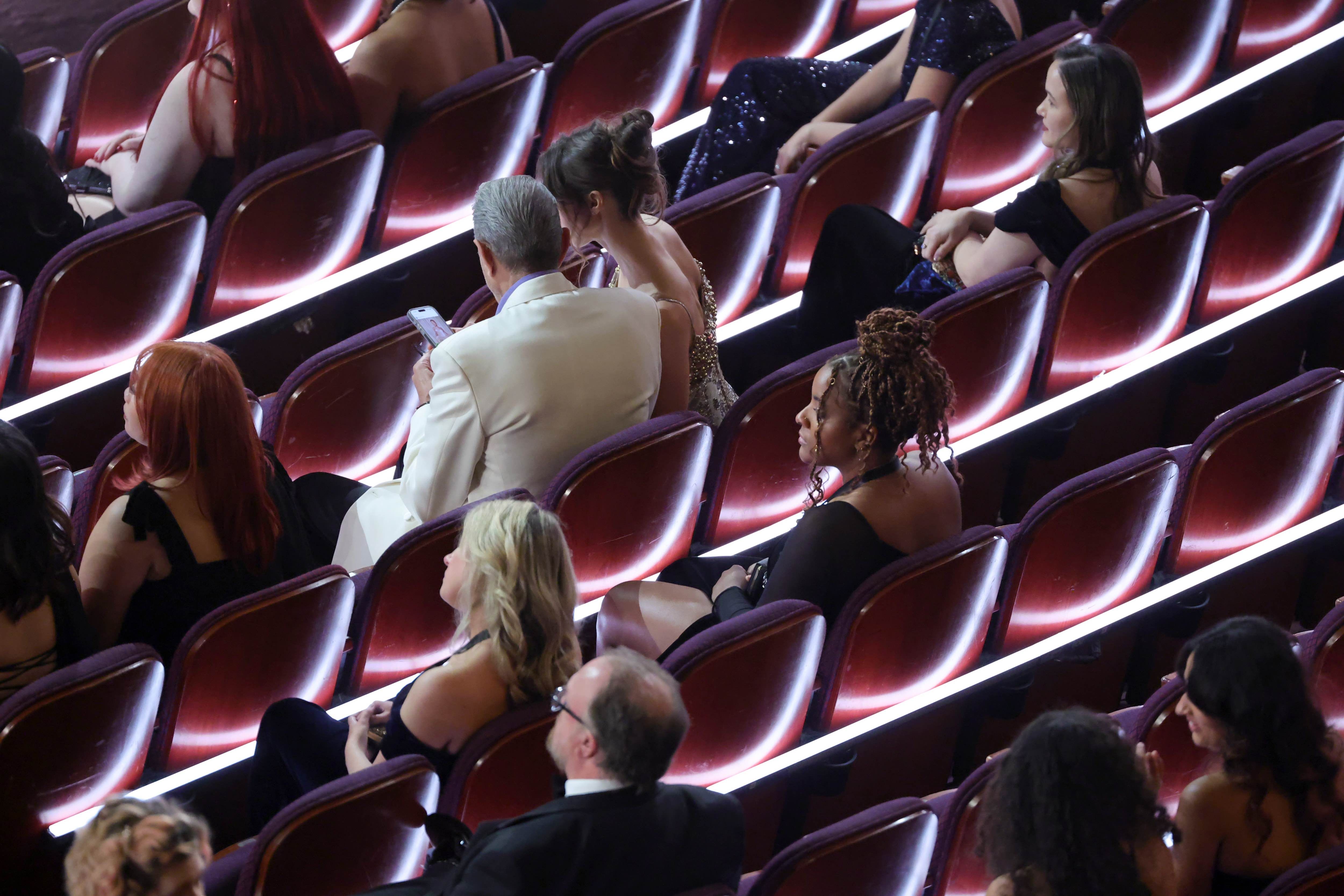 Jeff Goldblum and his wife Emilie Livingston checking out photos of Goldblum on the Oscars red carpet
