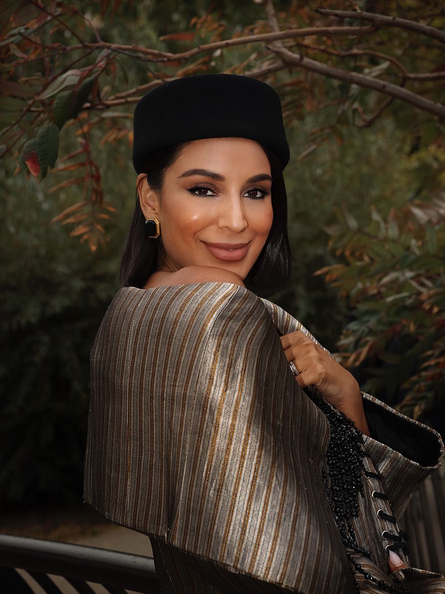 RHONY star Jessel Taank in a Réik off-shoulder jacket, Demarson earrings, Gigi Burris pillbox hat 