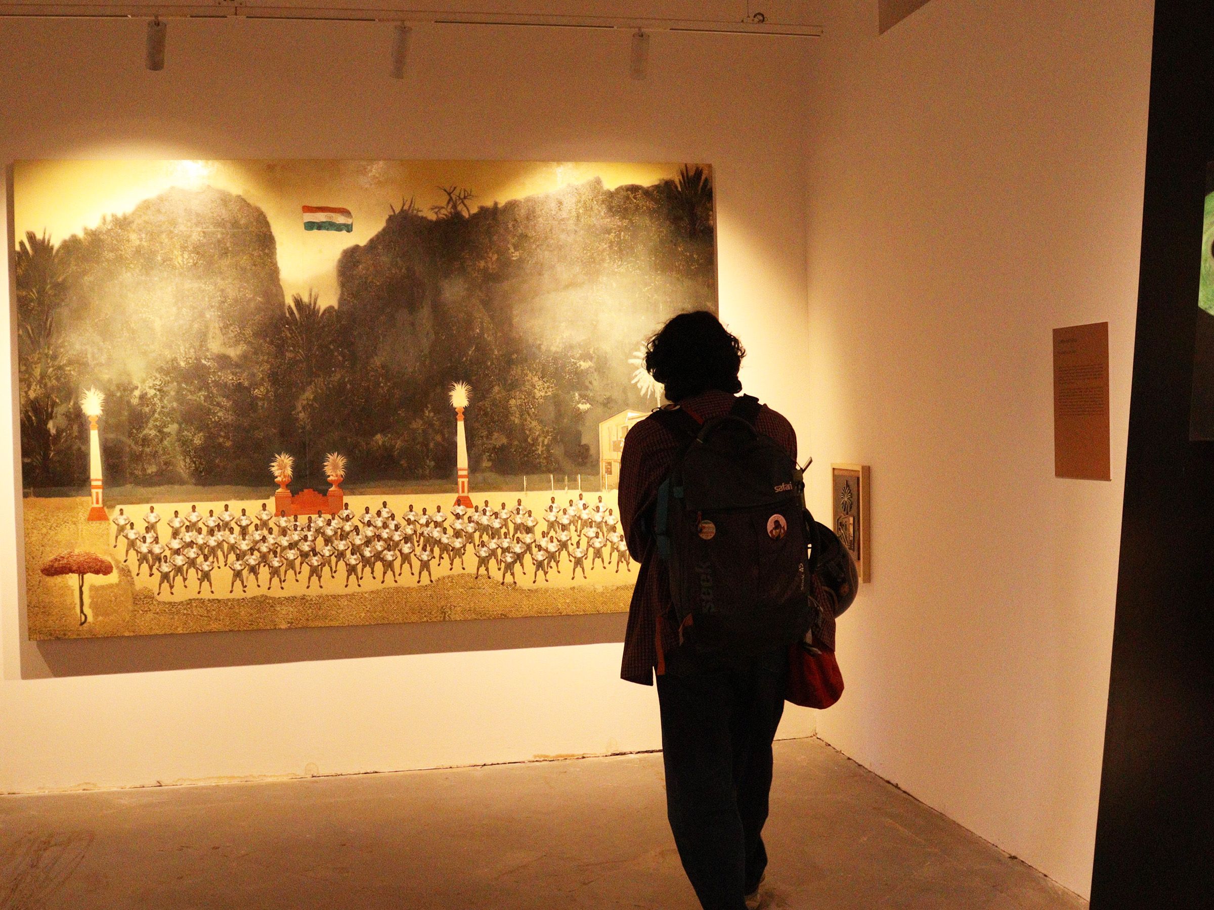 A visitor looking at the painting