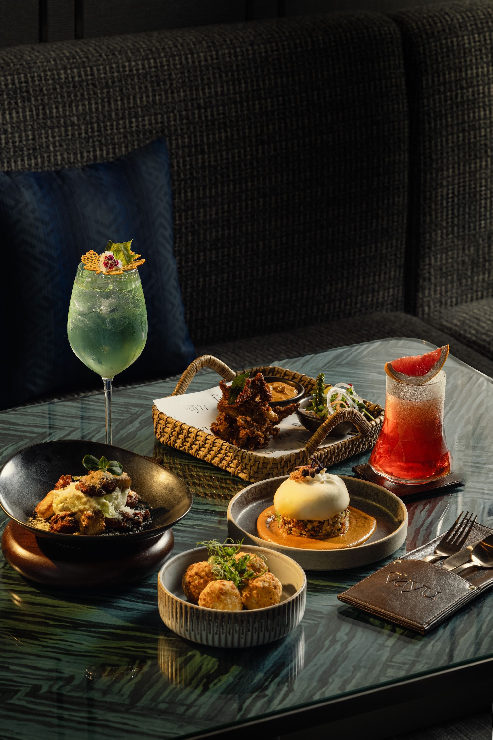 Top, L-R_ Karuveppilai ceaser salad, Nethli Pepper Fry. Bottom_ L-R_ Dahi Papad ke Kebab, Millet & Burrata.jpg