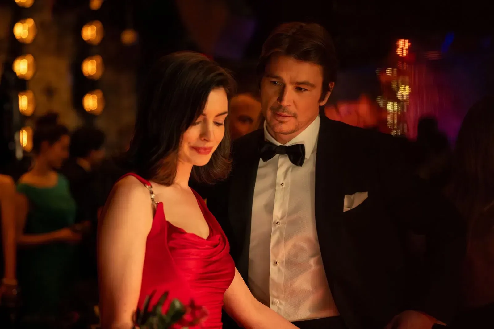 Anne Hathaway as Verity Crawford in a red Versace dress