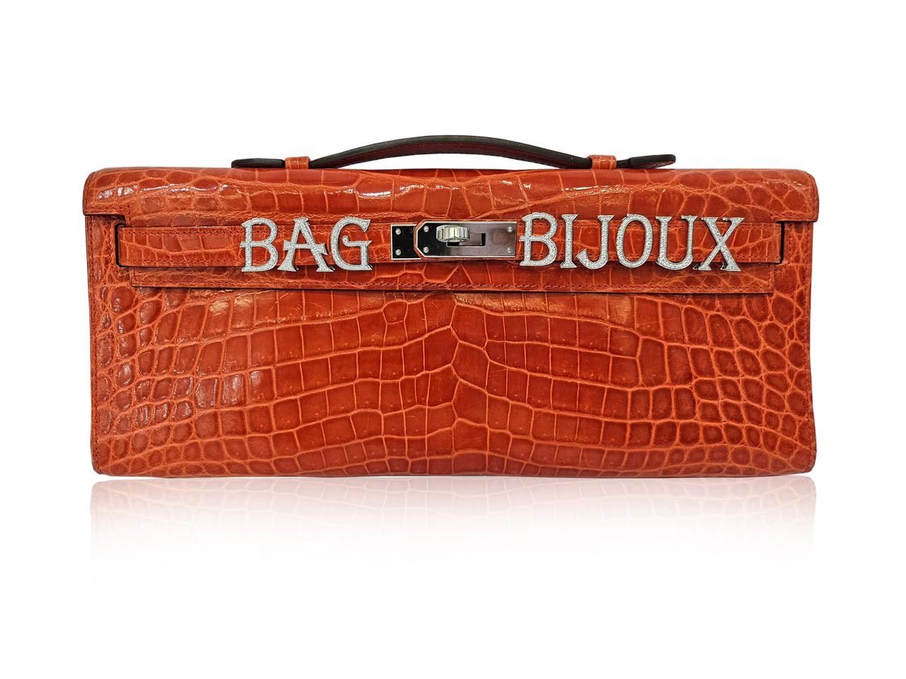 An Hermès bag with AM's bag bijoux alphabet charms