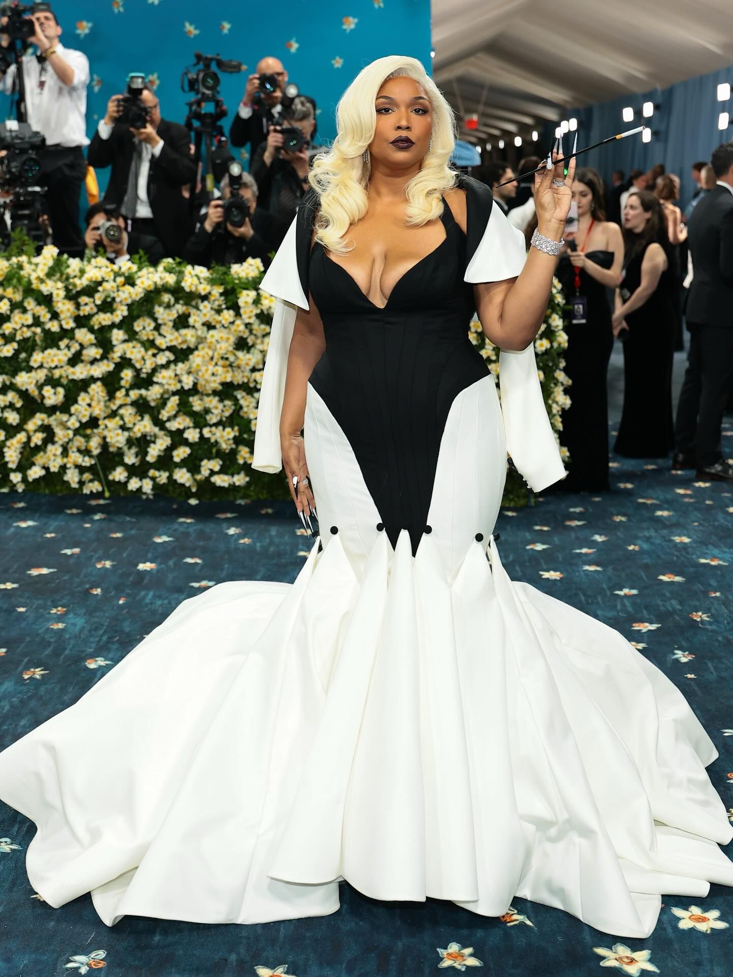 Lizzo in Christian Siriano at the 2025 Met Gala holding a cigarette extender