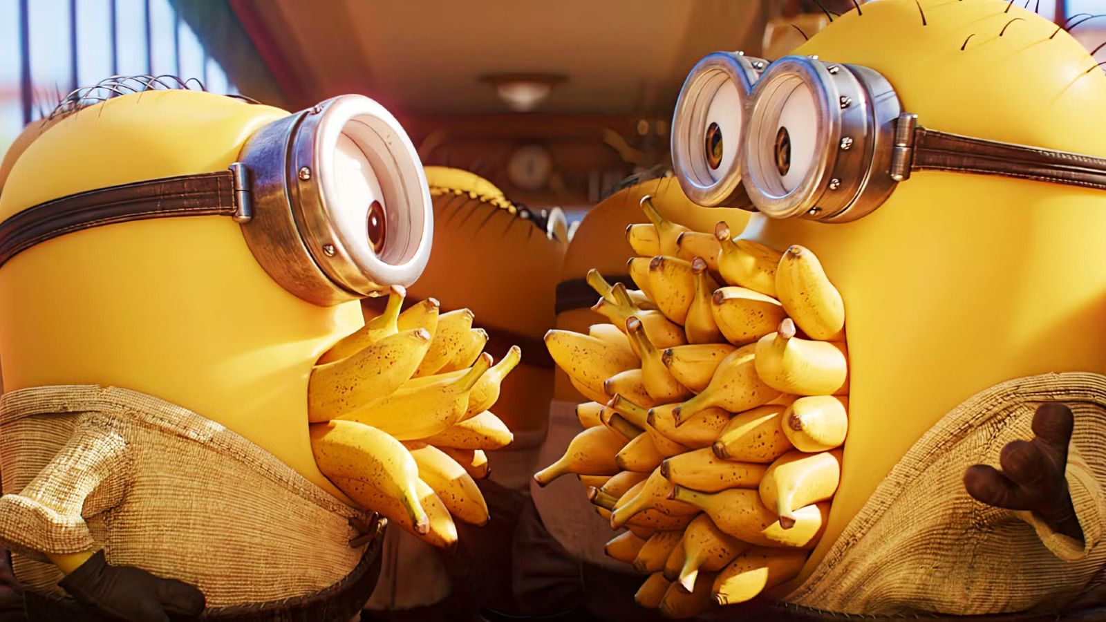 two-minions-facing-one-another-with-their-mouths-full-of-bananas-in-minions-monsters.jpg